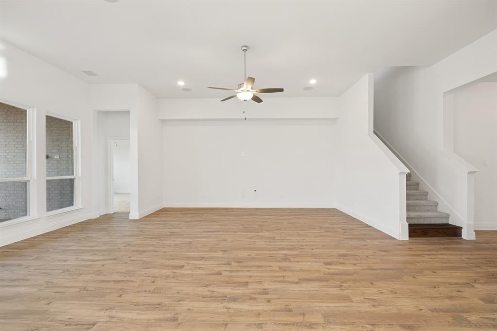 735 Oak Lavon, TX 75166 - Photo 20 of 39 a view of an empty room with wooden floor and ceiling fan