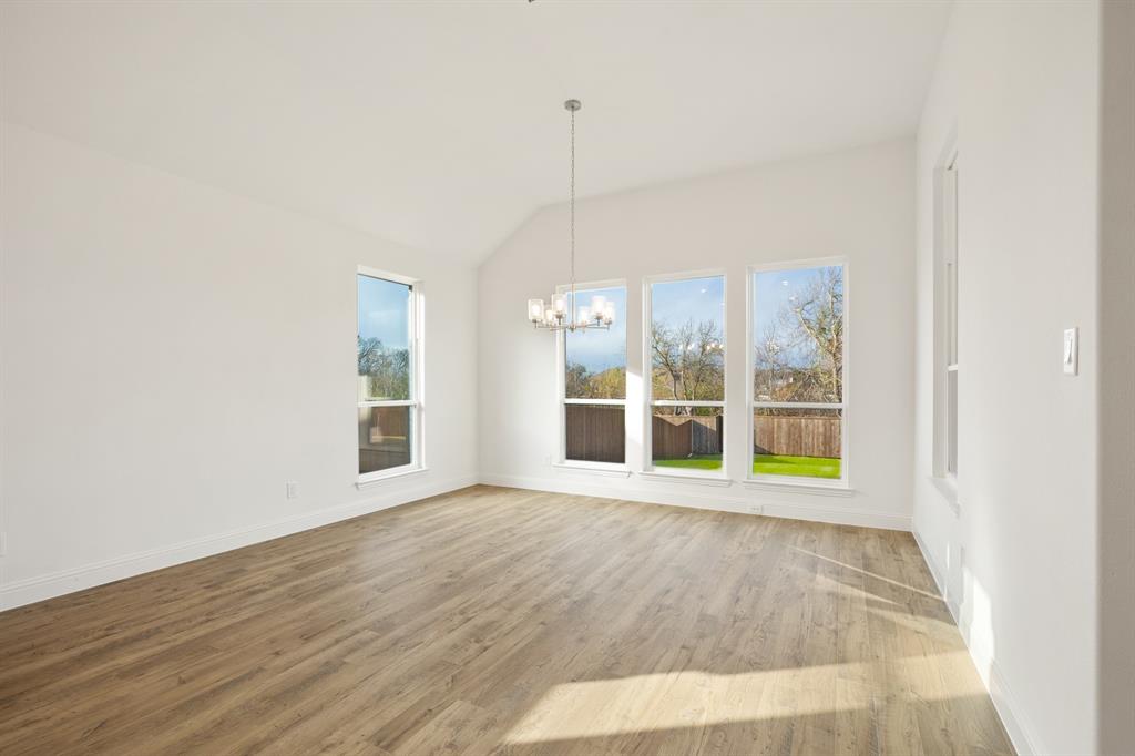 735 Oak Lavon, TX 75166 - Photo 21 of 39 a view of an empty room with wooden floor and a window