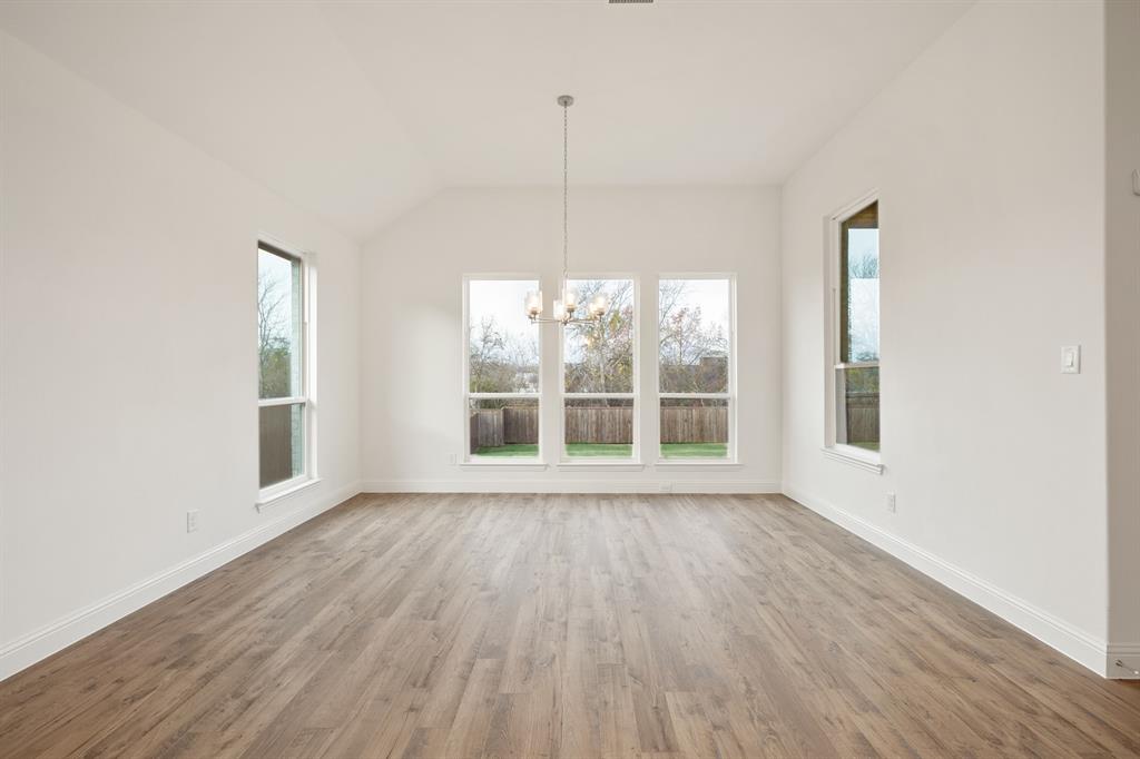 735 Oak Lavon, TX 75166 - Photo 25 of 39 a view of an empty room with wooden floor and a window