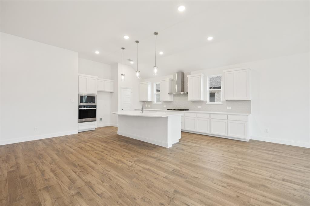 735 Oak Lavon, TX 75166 - Photo 26 of 39 a large kitchen with kitchen island a sink stainless steel appliances and cabinets