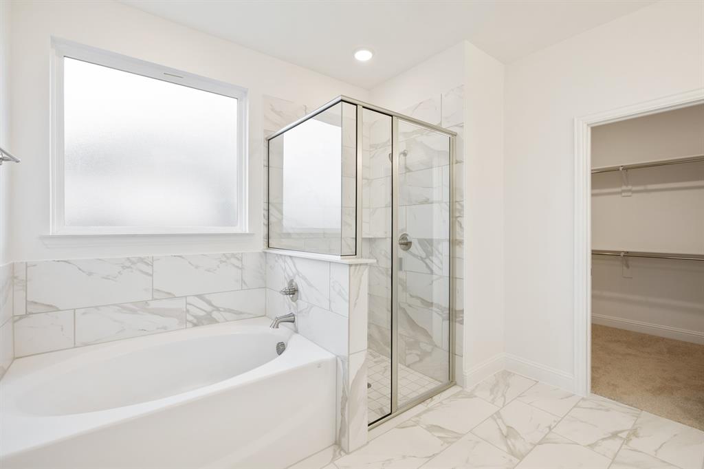 735 Oak Lavon, TX 75166 - Photo 30 of 39 a bathroom with a bathtub and a shower