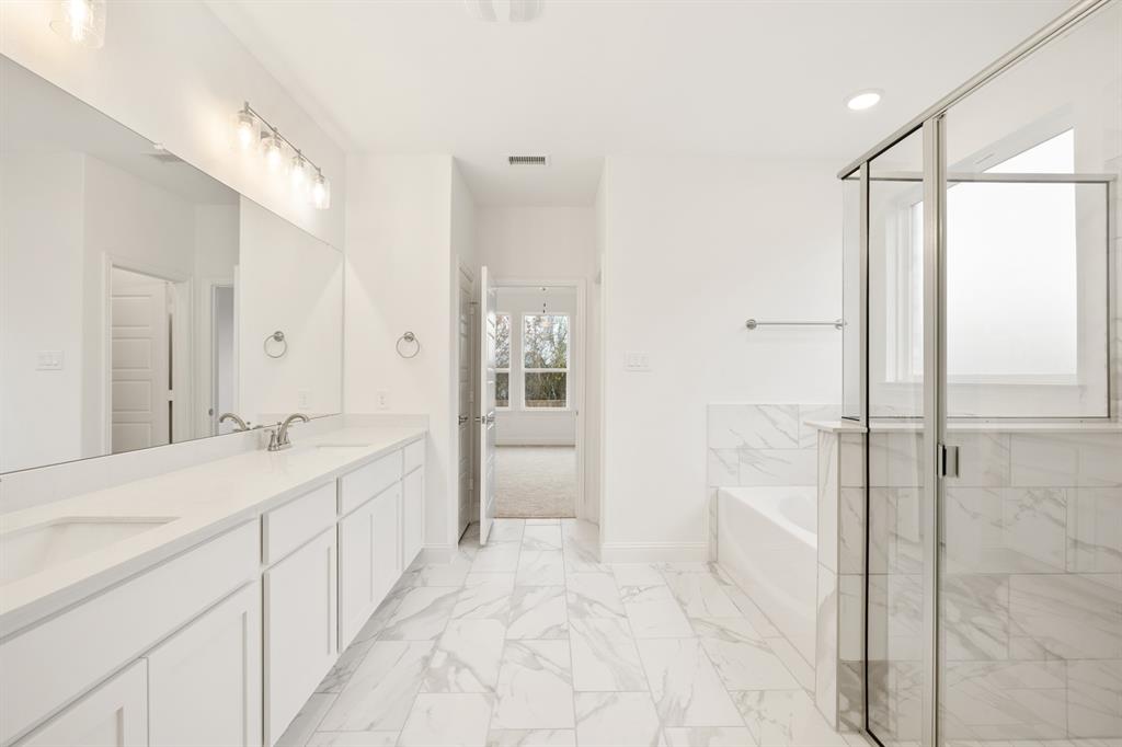 735 Oak Lavon, TX 75166 - Photo 32 of 39 a spacious bathroom with a shower sink and mirror