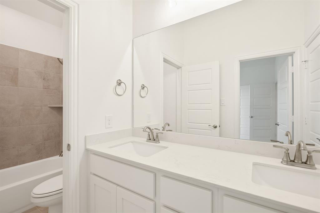 735 Oak Lavon, TX 75166 - Photo 6 of 39 a bathroom with a sink a toilet and shower