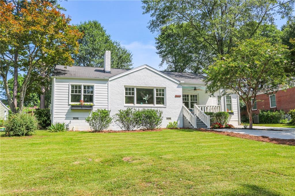 a front view of house with yard and green space