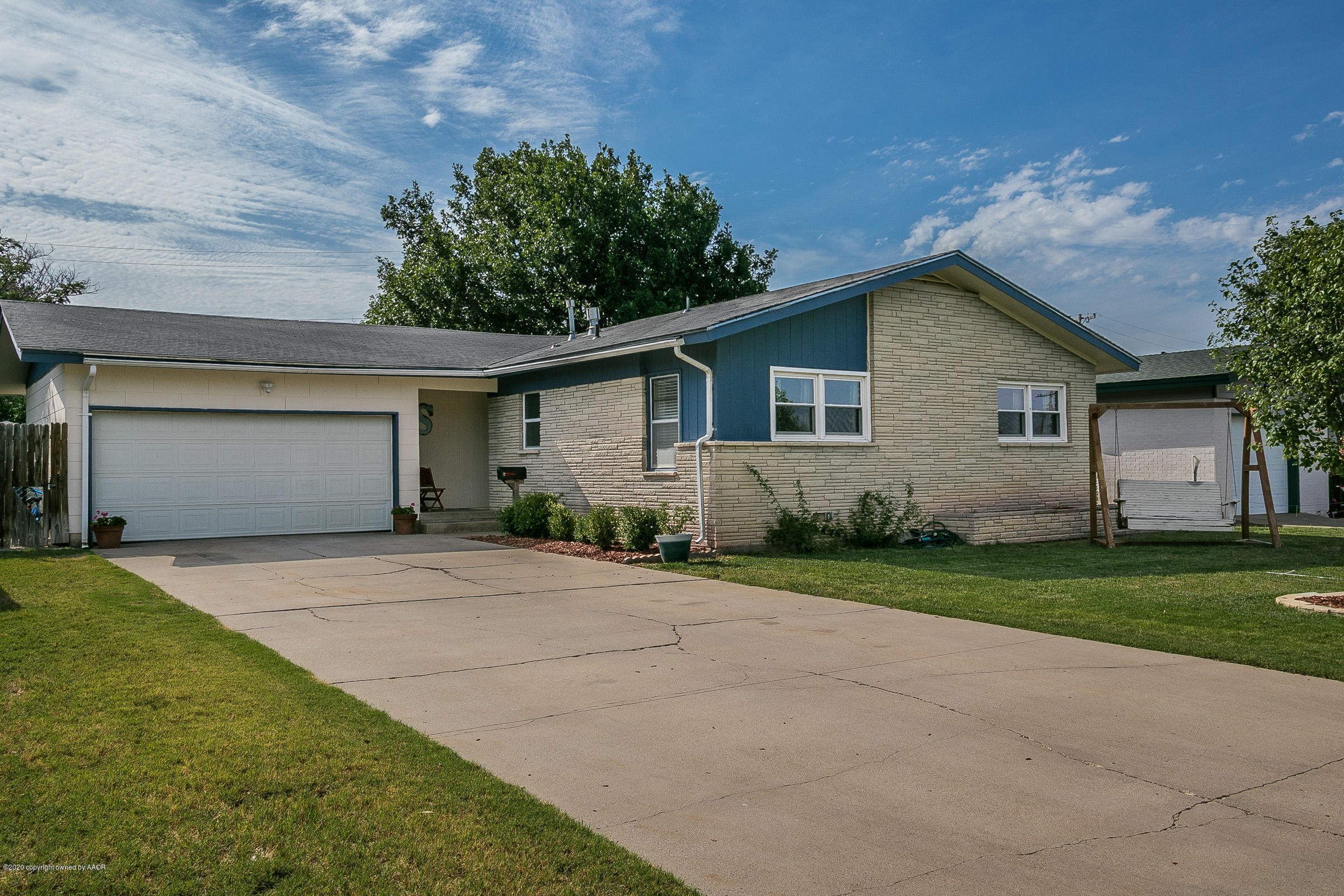 4709 South Austin Street Amarillo, TX 79110 - Photo 1 of 22 a front view of a house with a yard and garage