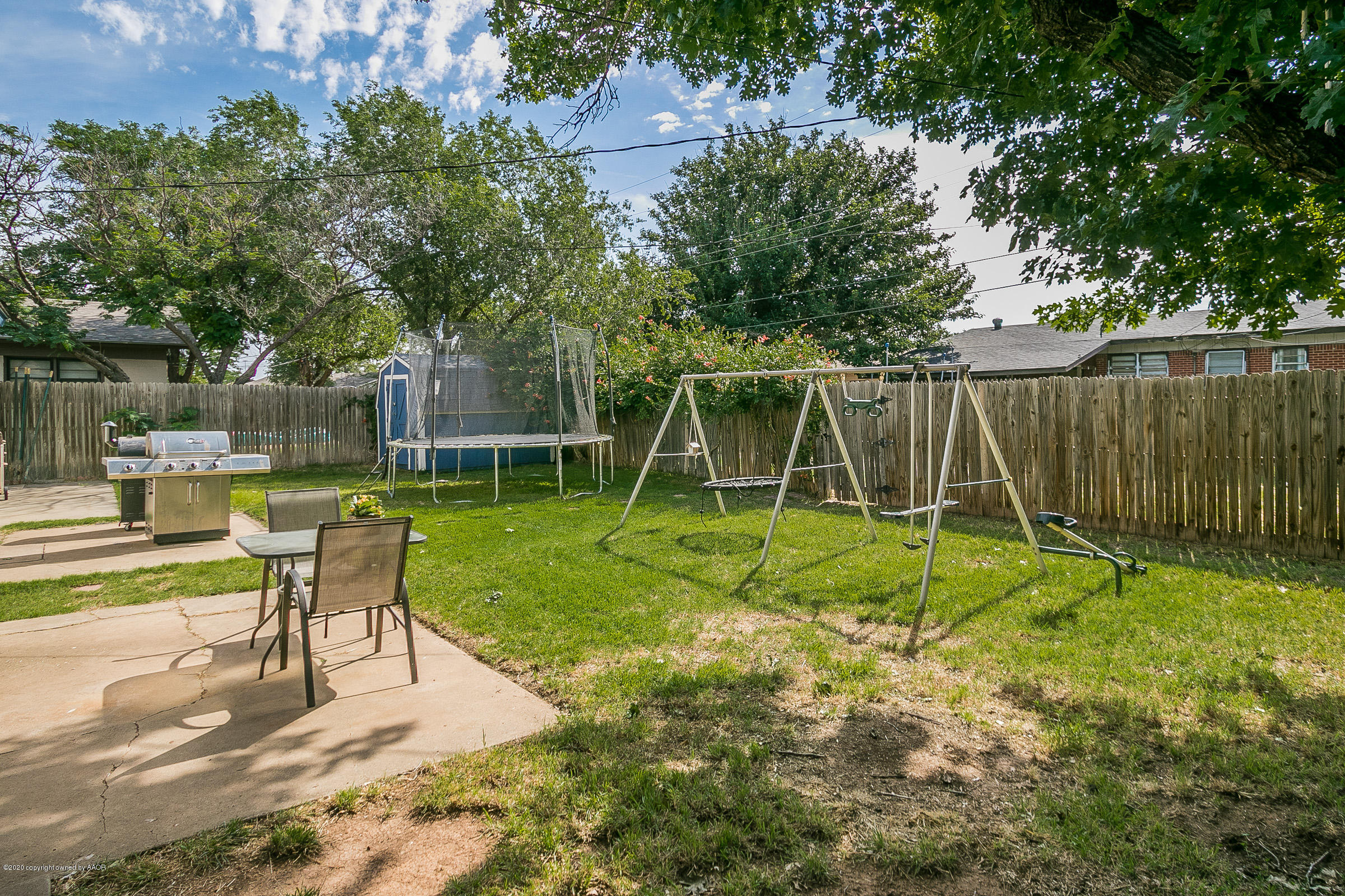4709 South Austin Street Amarillo, TX 79110 - Photo 20 of 22 a view of a house with a backyard and a slide