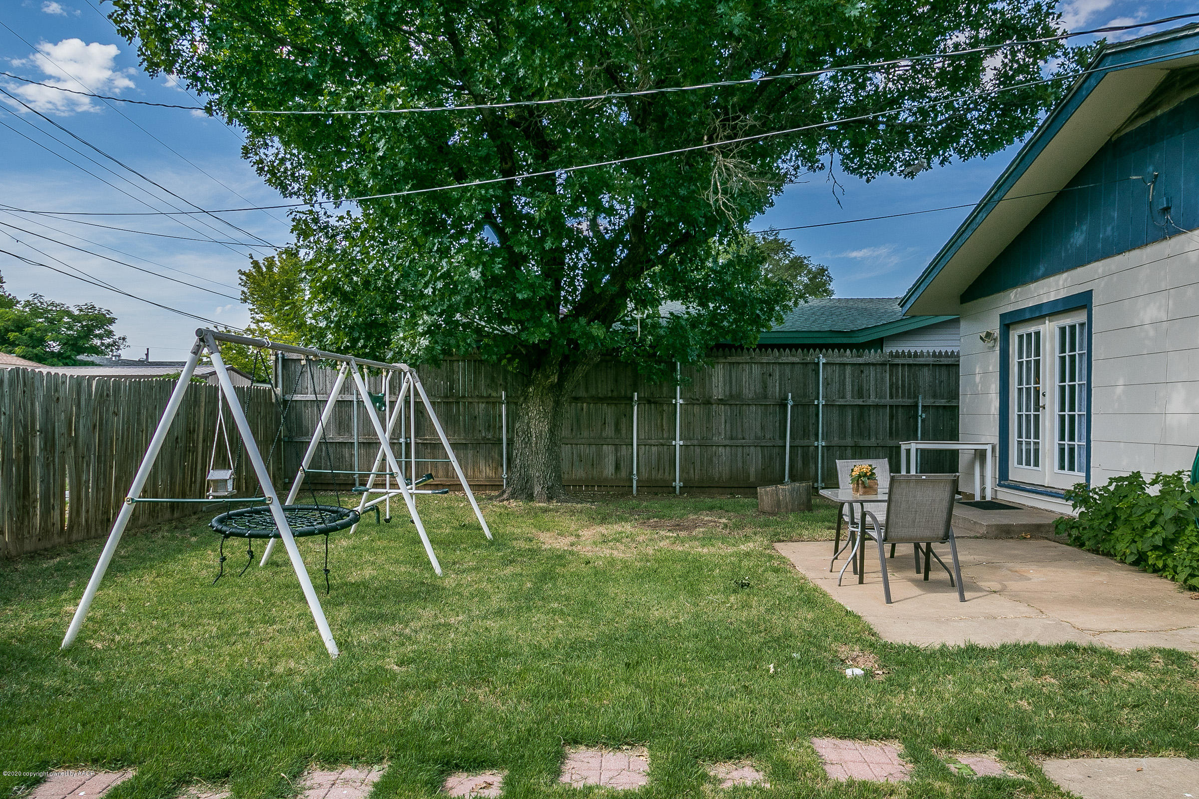 4709 South Austin Street Amarillo, TX 79110 - Photo 21 of 22 a garden with wooden fence and a slide