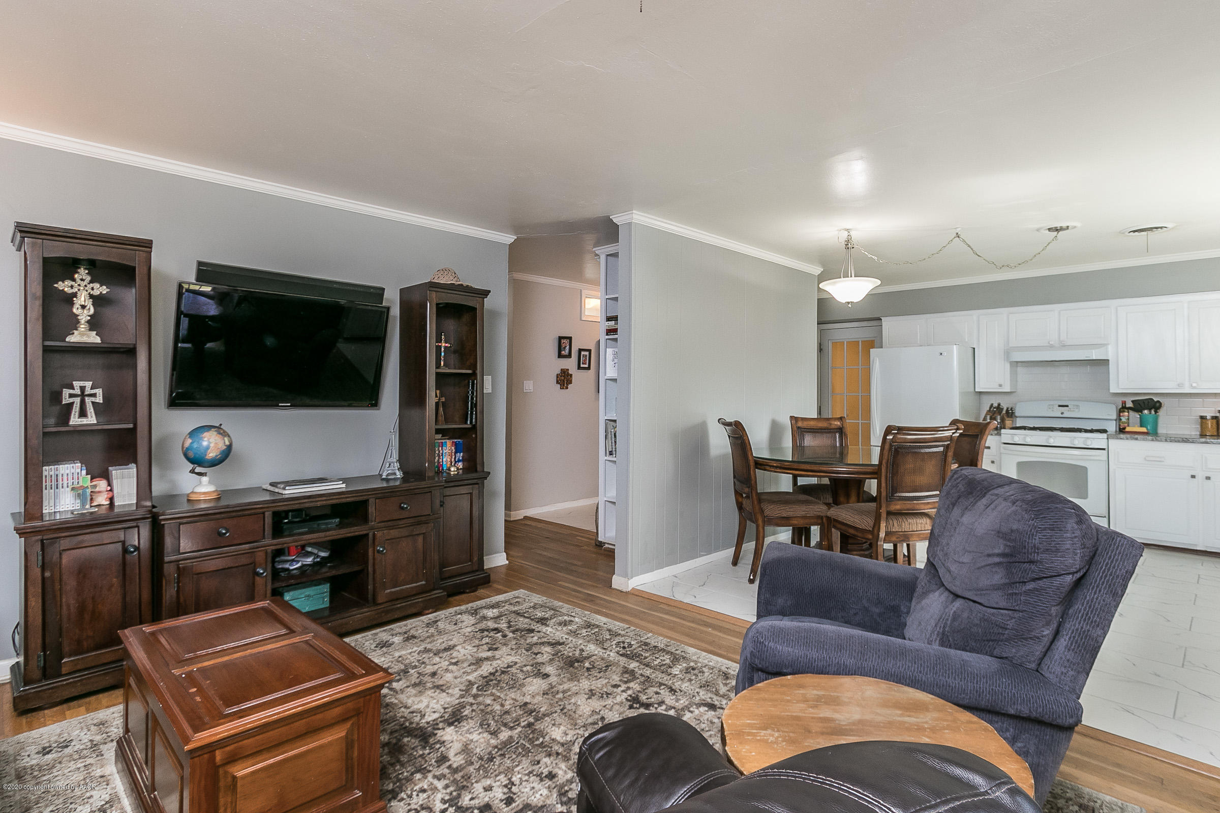 4709 South Austin Street Amarillo, TX 79110 - Photo 4 of 22 a living room with furniture and a flat screen tv