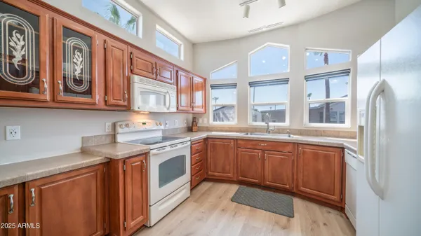 a kitchen with granite countertop a sink stainless steel appliances and cabinets