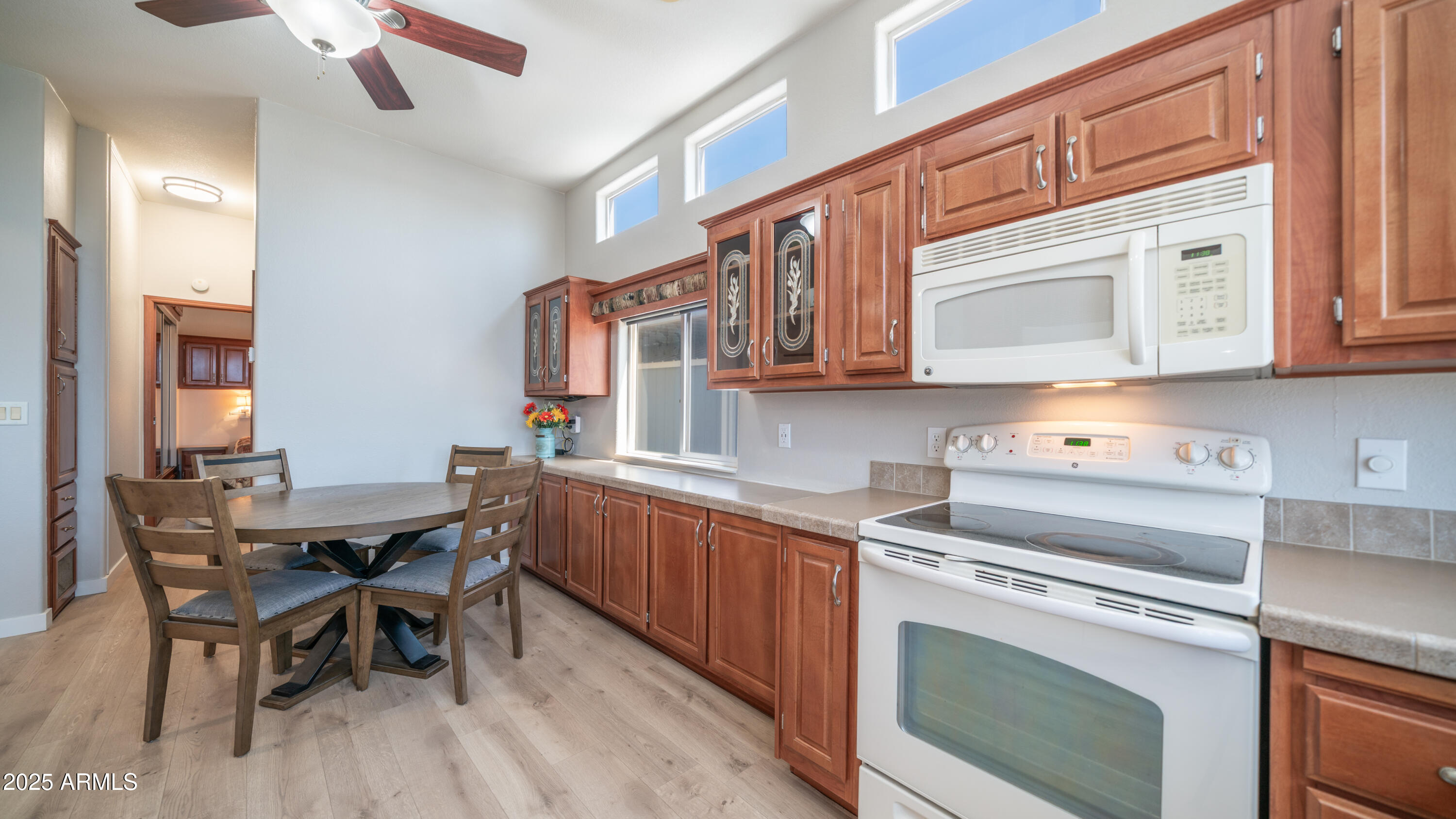 2400 East Baseline Avenue Apache Junction, AZ 85119 - Photo 17 of 64 a kitchen with stainless steel appliances granite countertop a white cabinets and a stove top oven