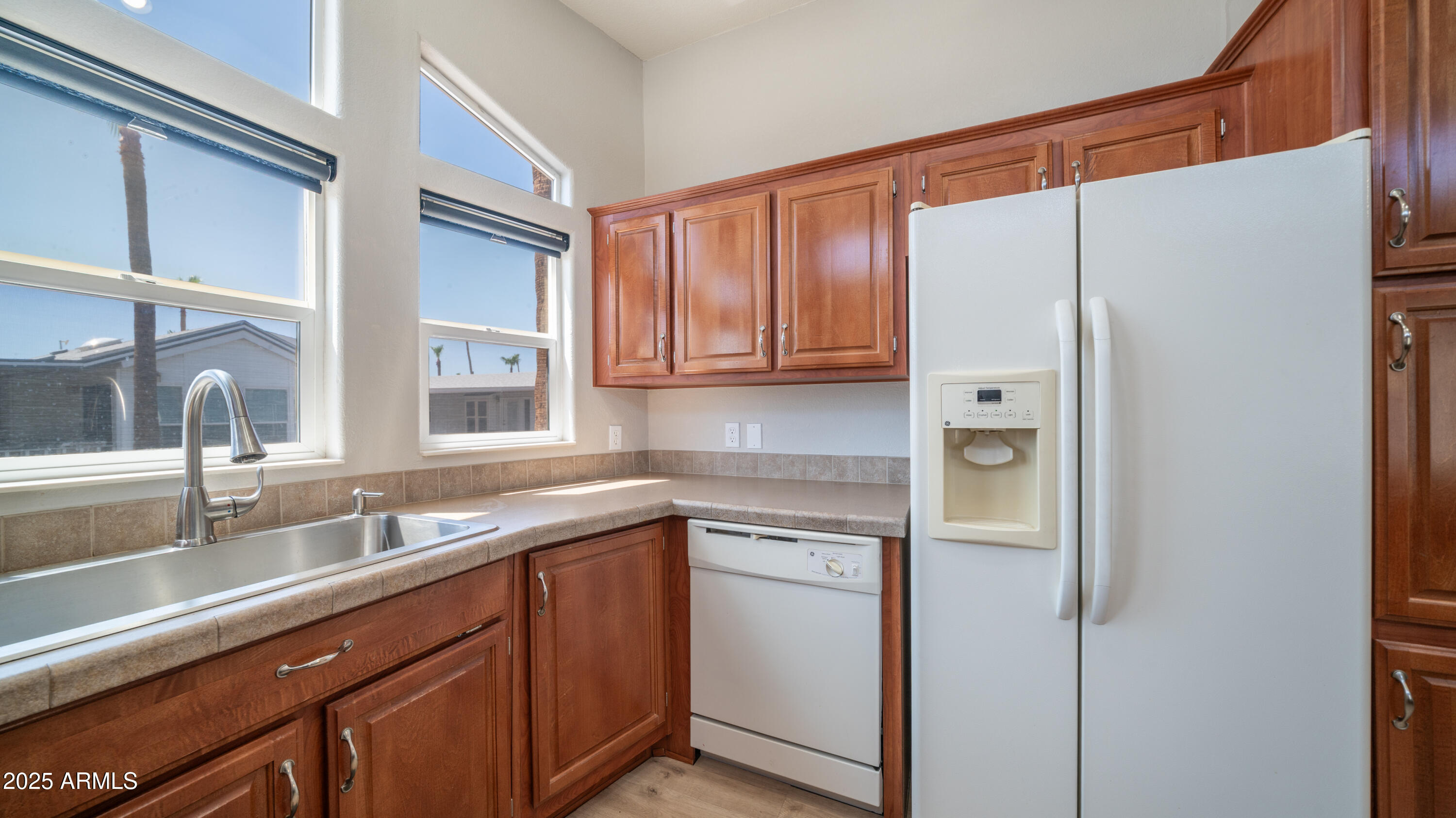 2400 East Baseline Avenue Apache Junction, AZ 85119 - Photo 18 of 64 a kitchen with a sink and refrigerator