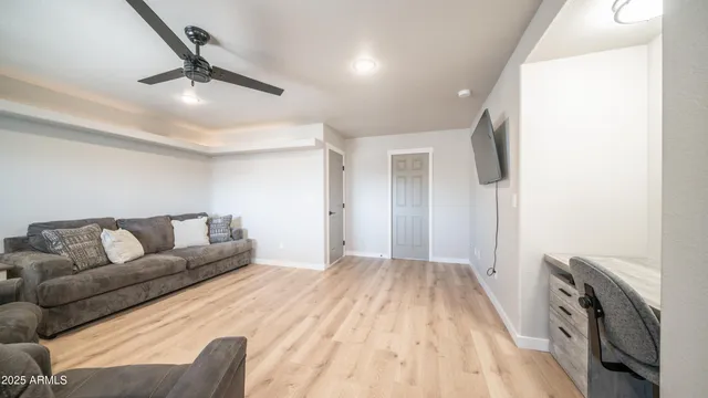 a living room with furniture and a chandelier