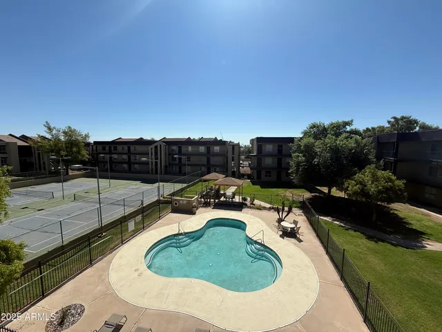 a view of a swimming pool with a patio and a garden
