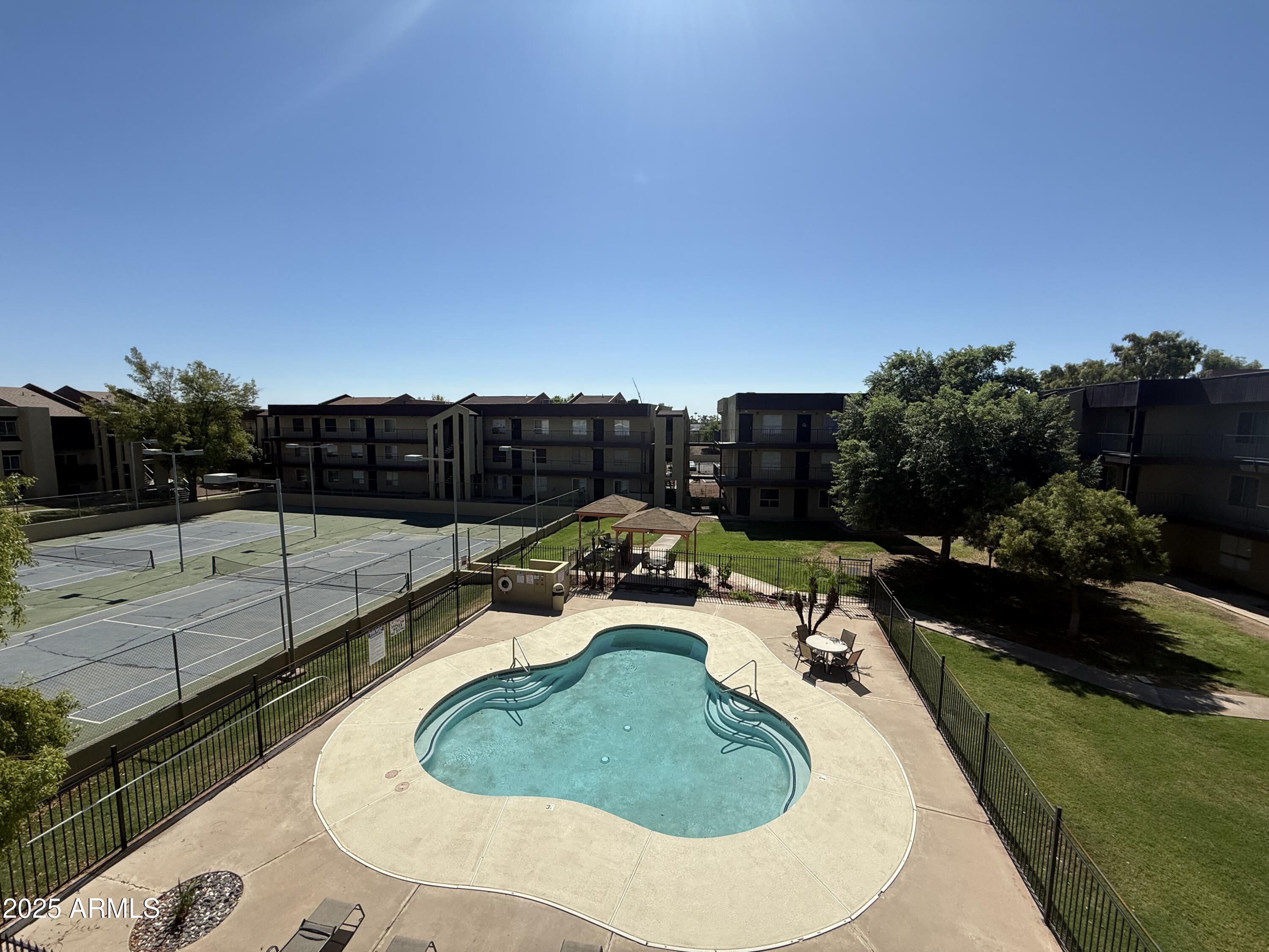 a view of a swimming pool with a patio and a garden