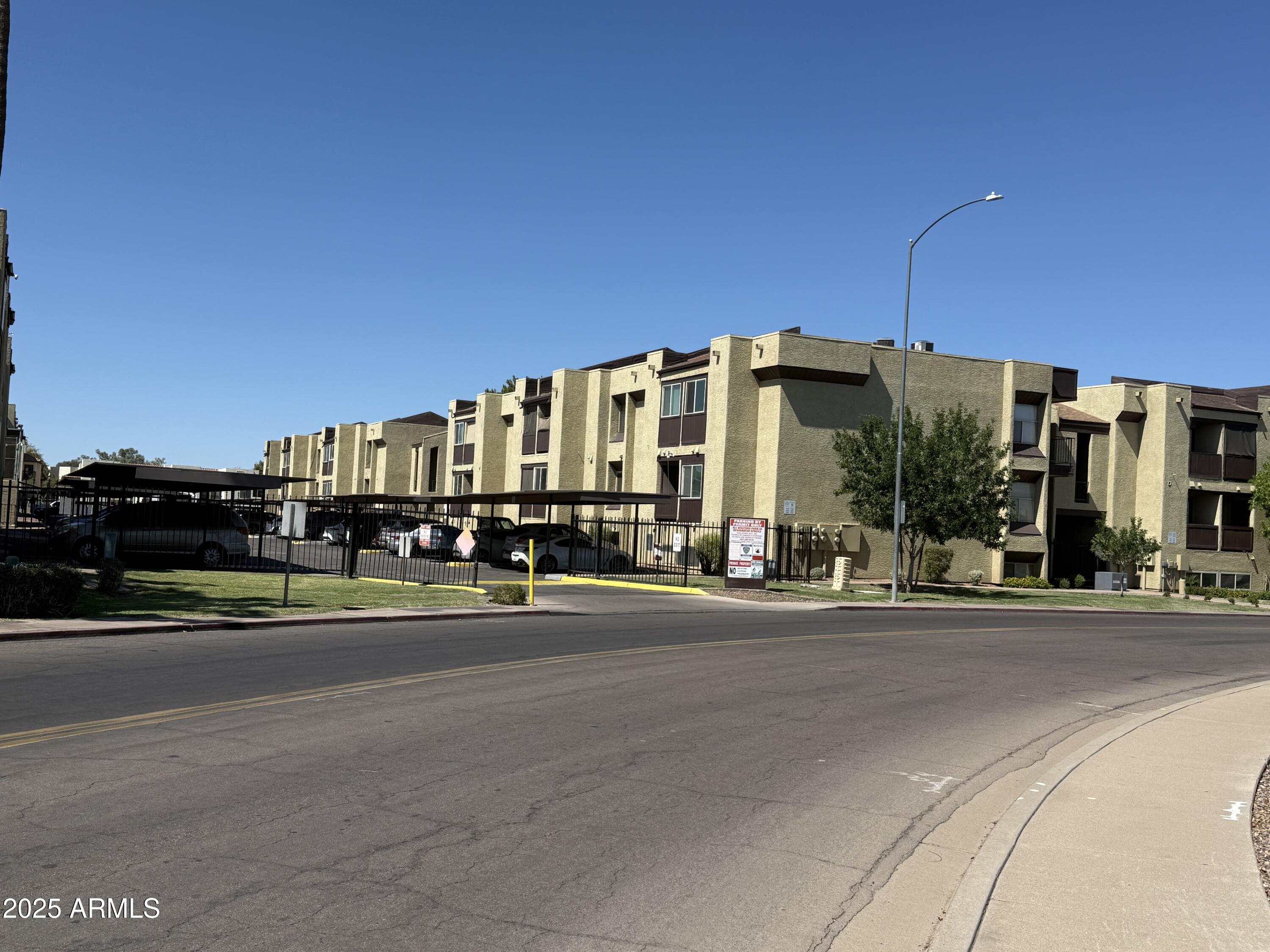 461 West Holmes Avenue, Unit 342 Mesa, AZ 85210 - Photo 3 of 21 a view of a tall building next to a road