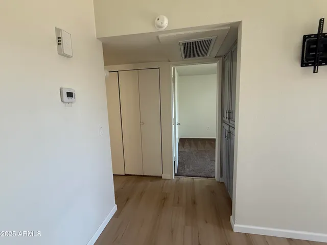 a view of a hallway with wooden floor