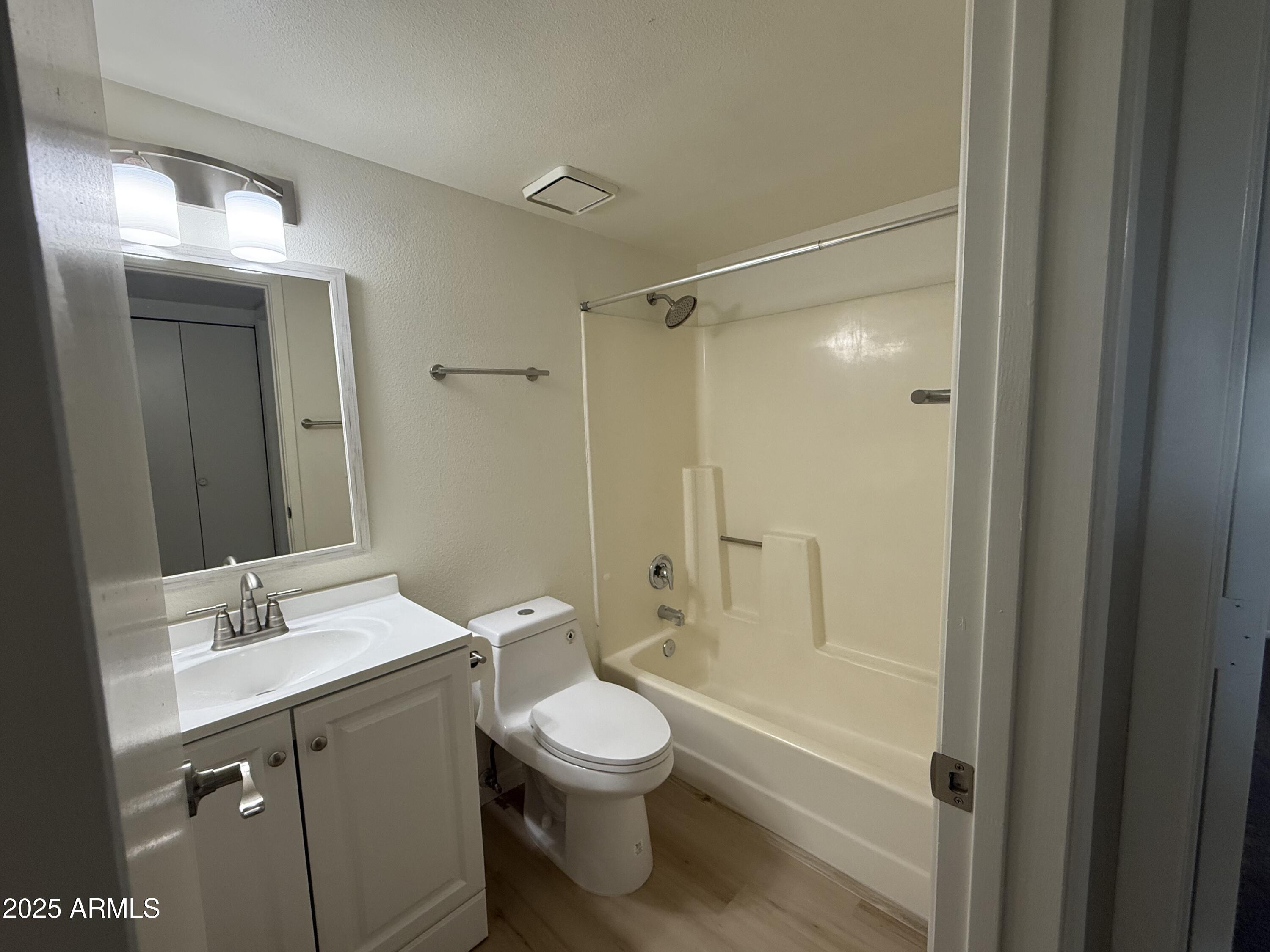 461 West Holmes Avenue, Unit 342 Mesa, AZ 85210 - Photo 9 of 21 a bathroom with a double vanity sink toilet mirror and shower
