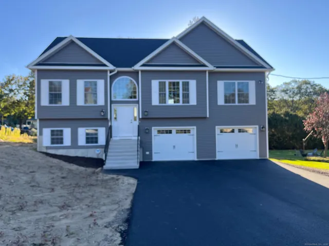 a front view of a house with a yard and swimming pool