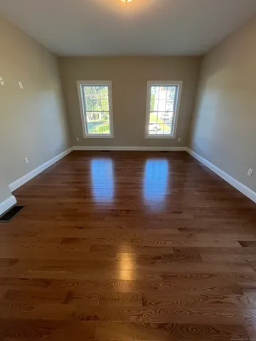 a bathroom with a granite countertop sink a mirror and a shower