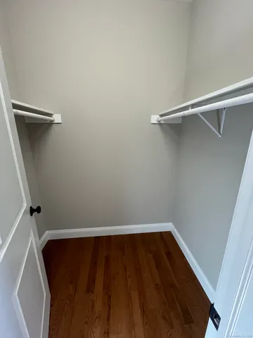 a bathroom with a granite countertop sink a toilet and a mirror