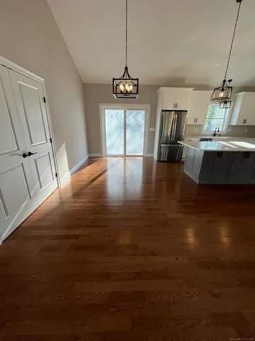 a view of a dining room with furniture wooden floor and chandelier