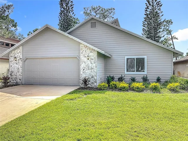 a front view of house with yard and green space