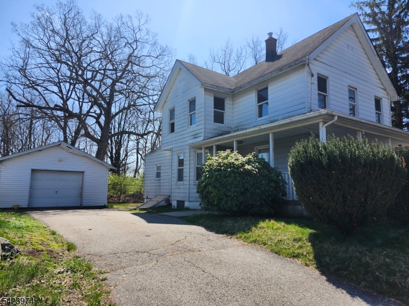 5 Locust Street Wanaque, NJ 07420 - Photo 2 of 23 a front view of a house with a garden
