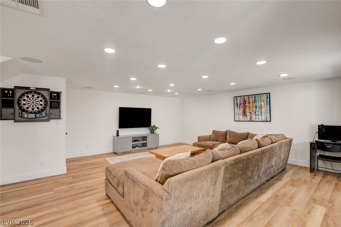 4362 Thistle Street Logandale, NV 89021 - Photo 46 of 99 A spacious lower-level entertainment area boasts ample seating and recessed lighting, ideal for gatherings.