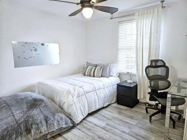 a bedroom with a bed and window