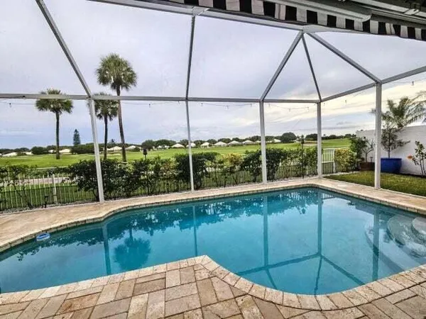 a view of a backyard and swimming pool