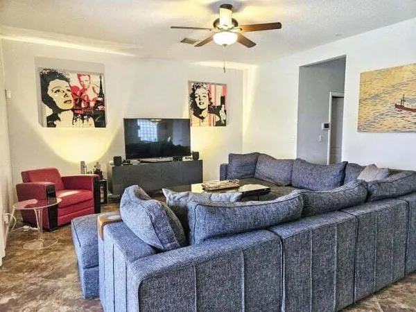 a living room with furniture and a flat screen tv