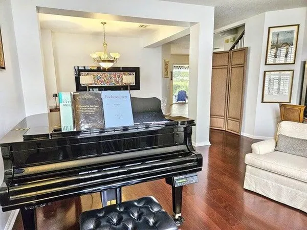 a living room with furniture and wooden floor