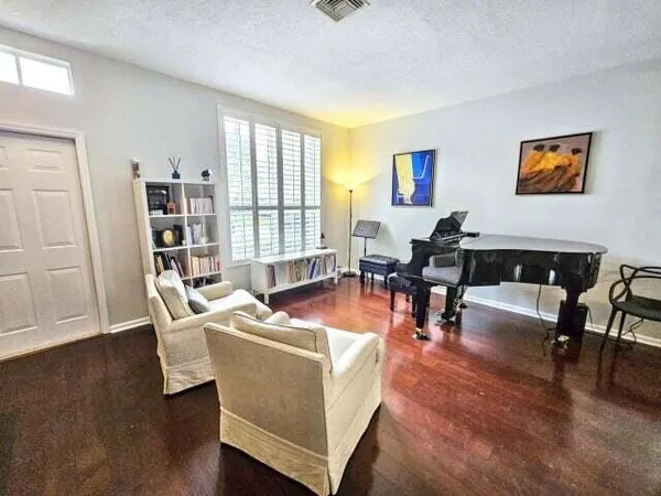 a living room with fireplace furniture and a wooden floor