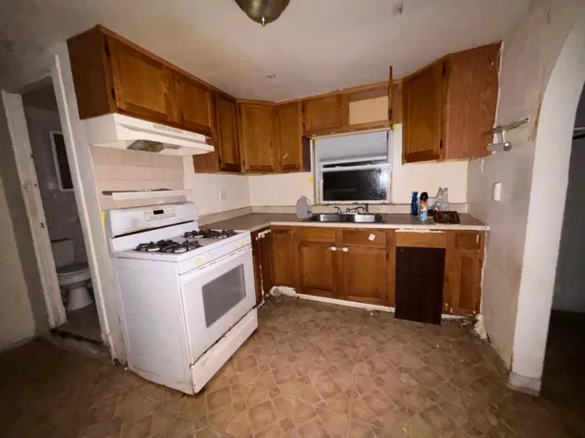 a kitchen with a stove sink and a microwave