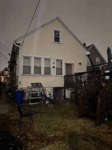 a house view with a sitting space fire pit and outdoor seating