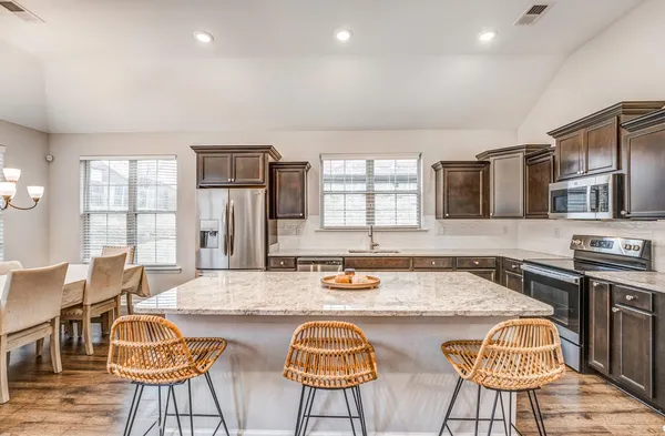 a dining table with chairs and wooden floor