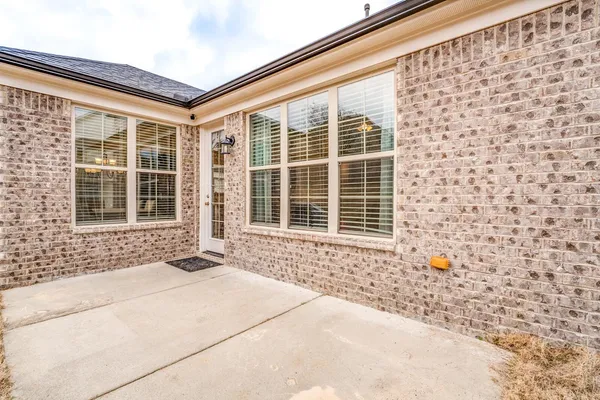 a view of a house with a yard and sitting area