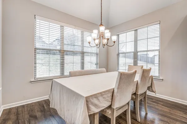 a view of a dining room with furniture wooden floor and chandelier