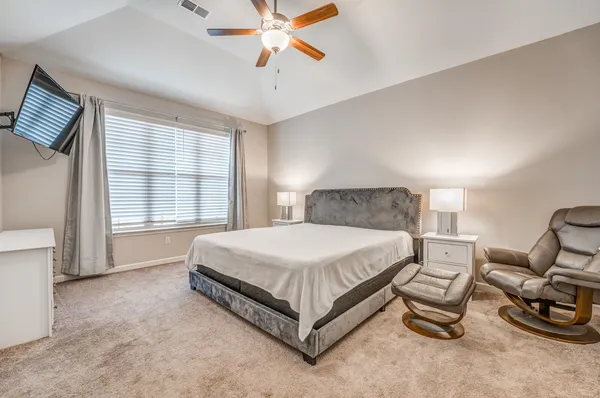 a bedroom with a bed and a chandelier