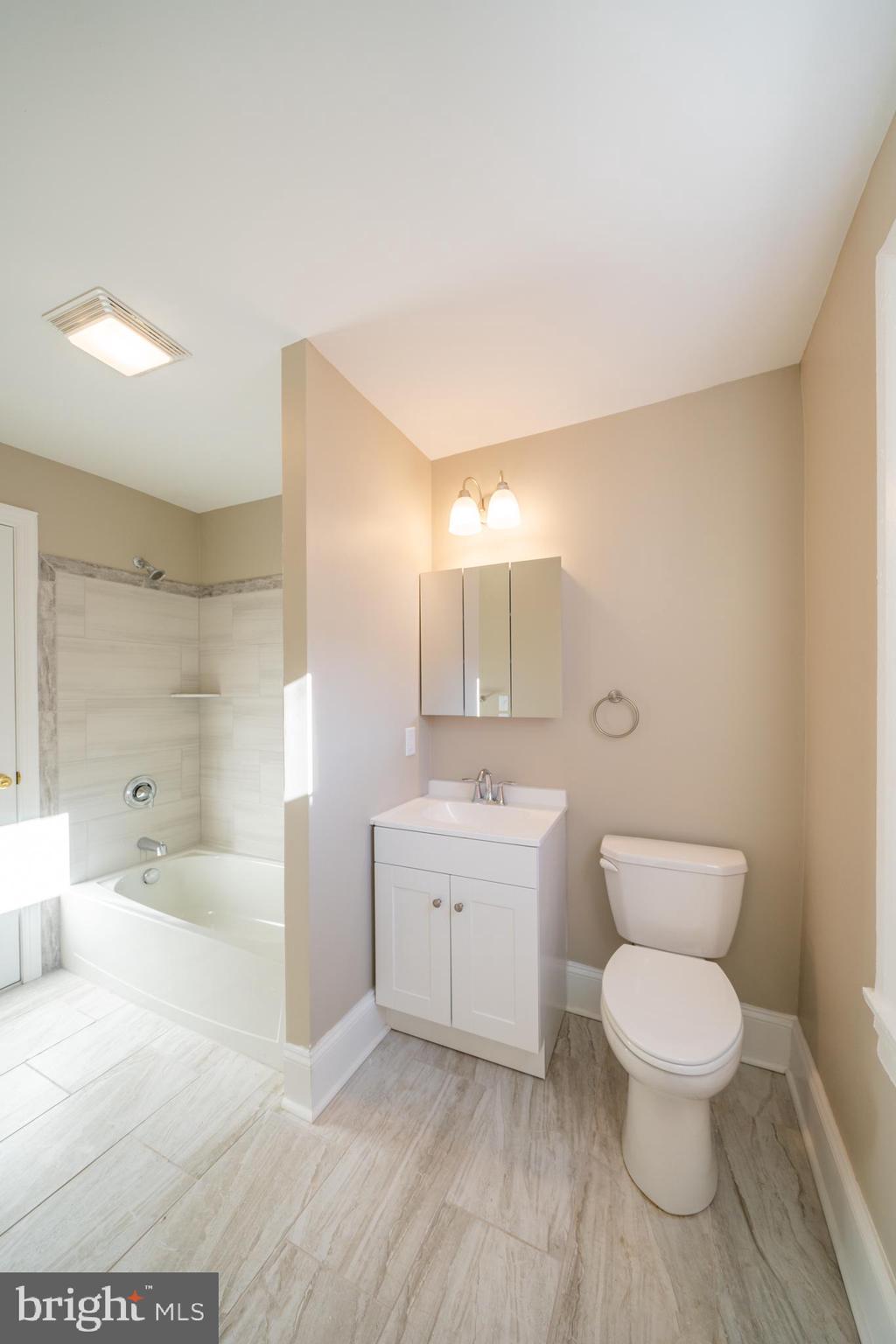 327 North High Street, Unit 1 West Chester, PA 19380 - Photo 11 of 13 a bathroom with a toilet a sink and bathtub