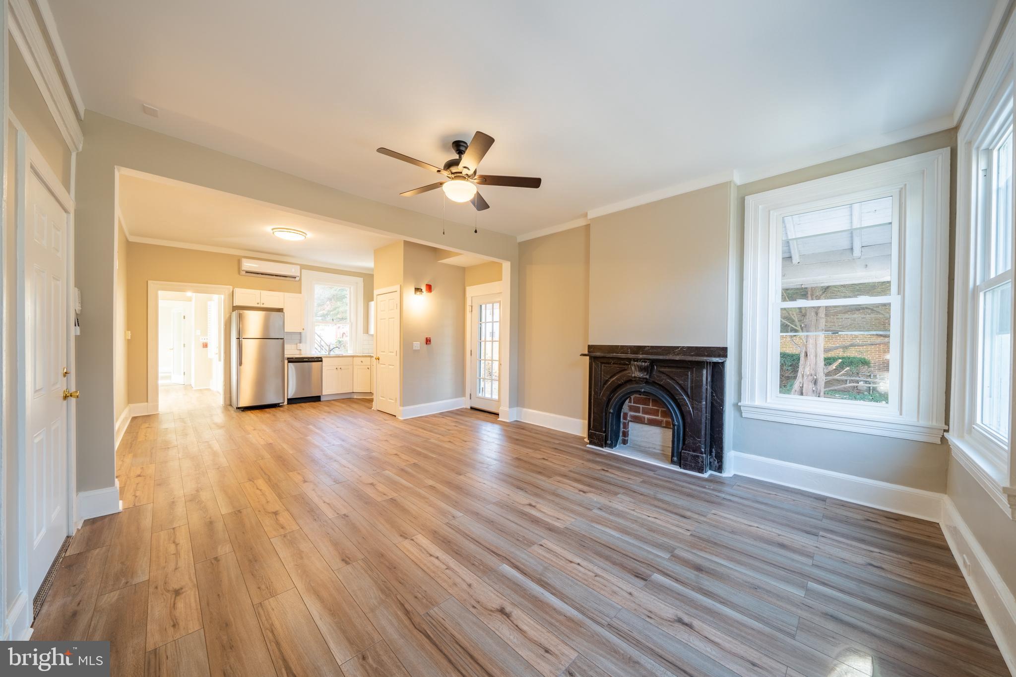 327 North High Street, Unit 1 West Chester, PA 19380 - Photo 8 of 13 a view of an empty room with wooden floor fireplace and a window