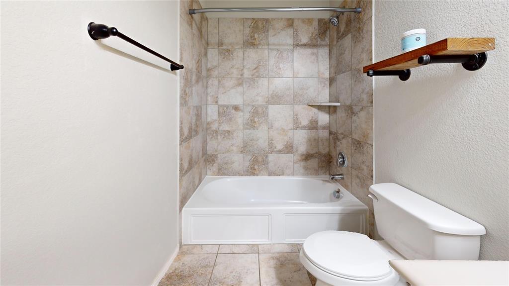 3101 Buckthorn Street Forney, TX 75126 - Photo 22 of 40 Full bathroom featuring a white tub, integrated shower, and tiled surround