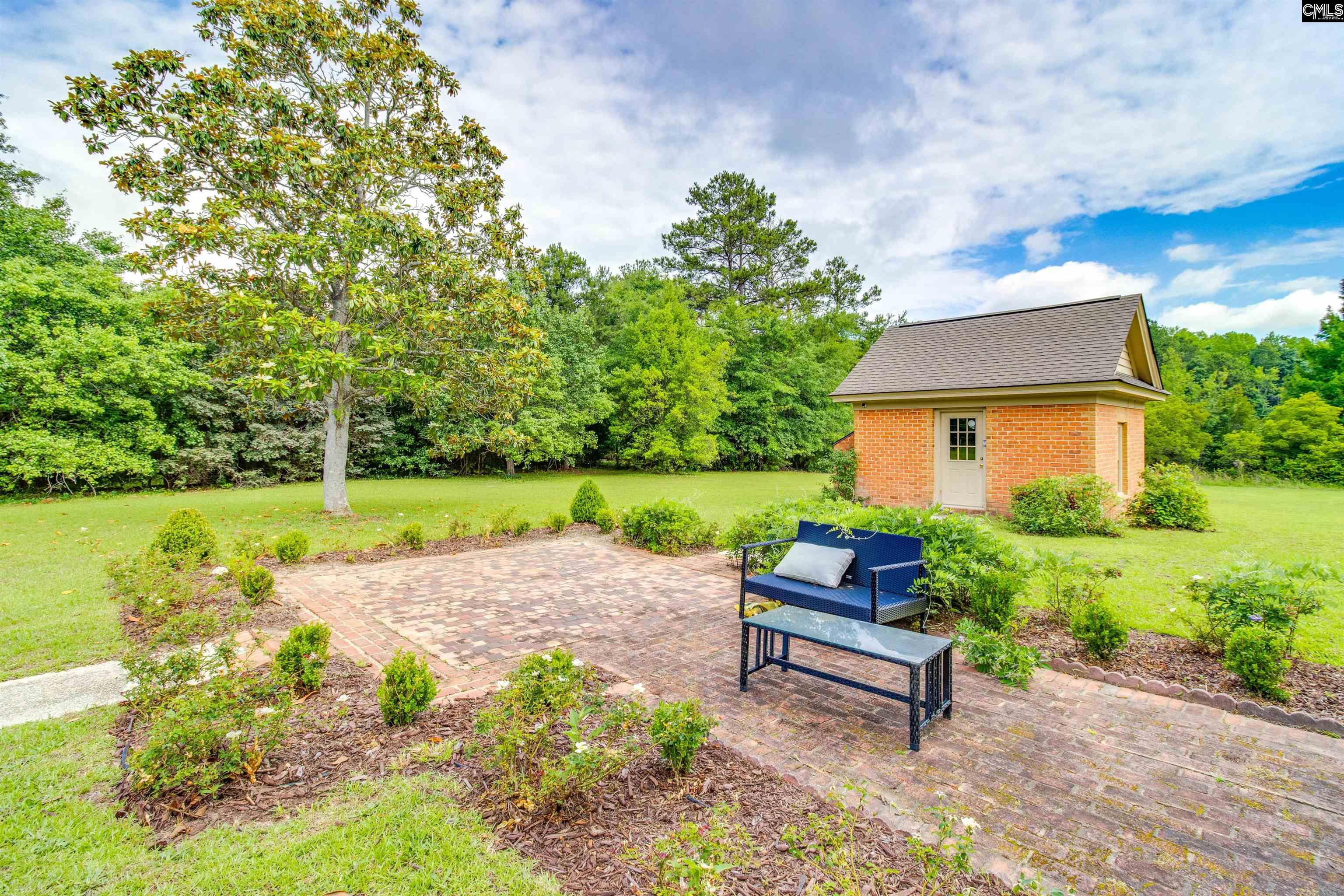 701 Longtown Road Columbia, SC 29229 - Photo 24 of 26 a bench sitting in middle of garden with wooden fence