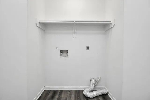 an empty room with wooden floor and window