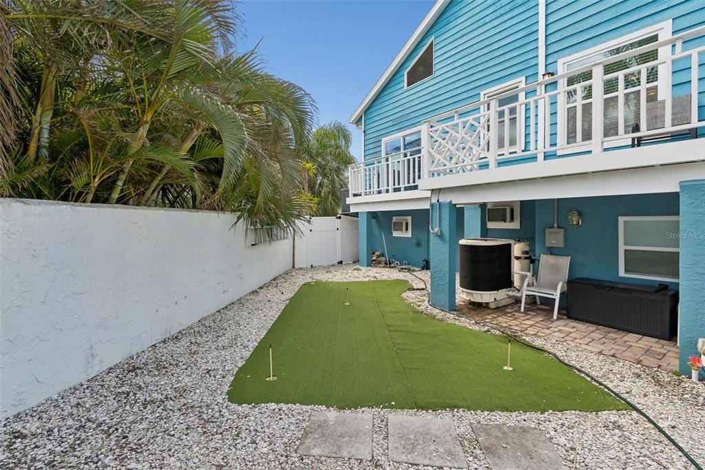 330 6th Avenue Indian Rocks Beach, FL 33785 - Photo 40 of 52 a view of a patio with table and chairs with wooden fence and plants
