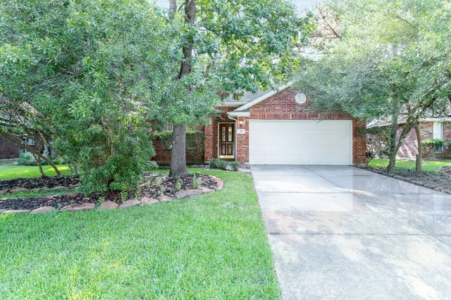a view of a house with a yard and tree