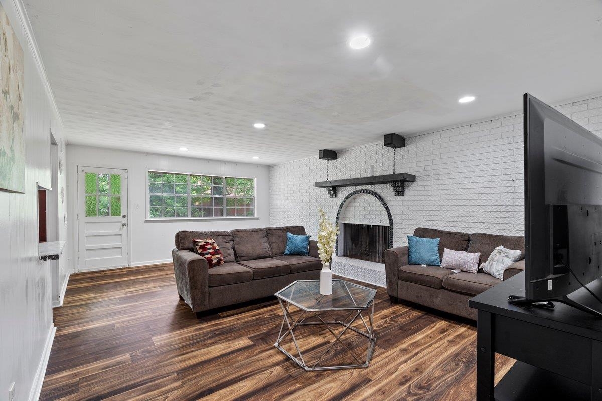 5841 Foxdale Road Memphis, TN 38115 - Photo 16 of 21 a living room with furniture a fireplace and a flat screen tv