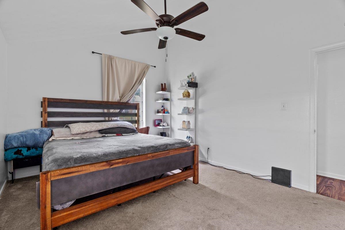 5841 Foxdale Road Memphis, TN 38115 - Photo 19 of 21 a bedroom with a bed and a chandelier