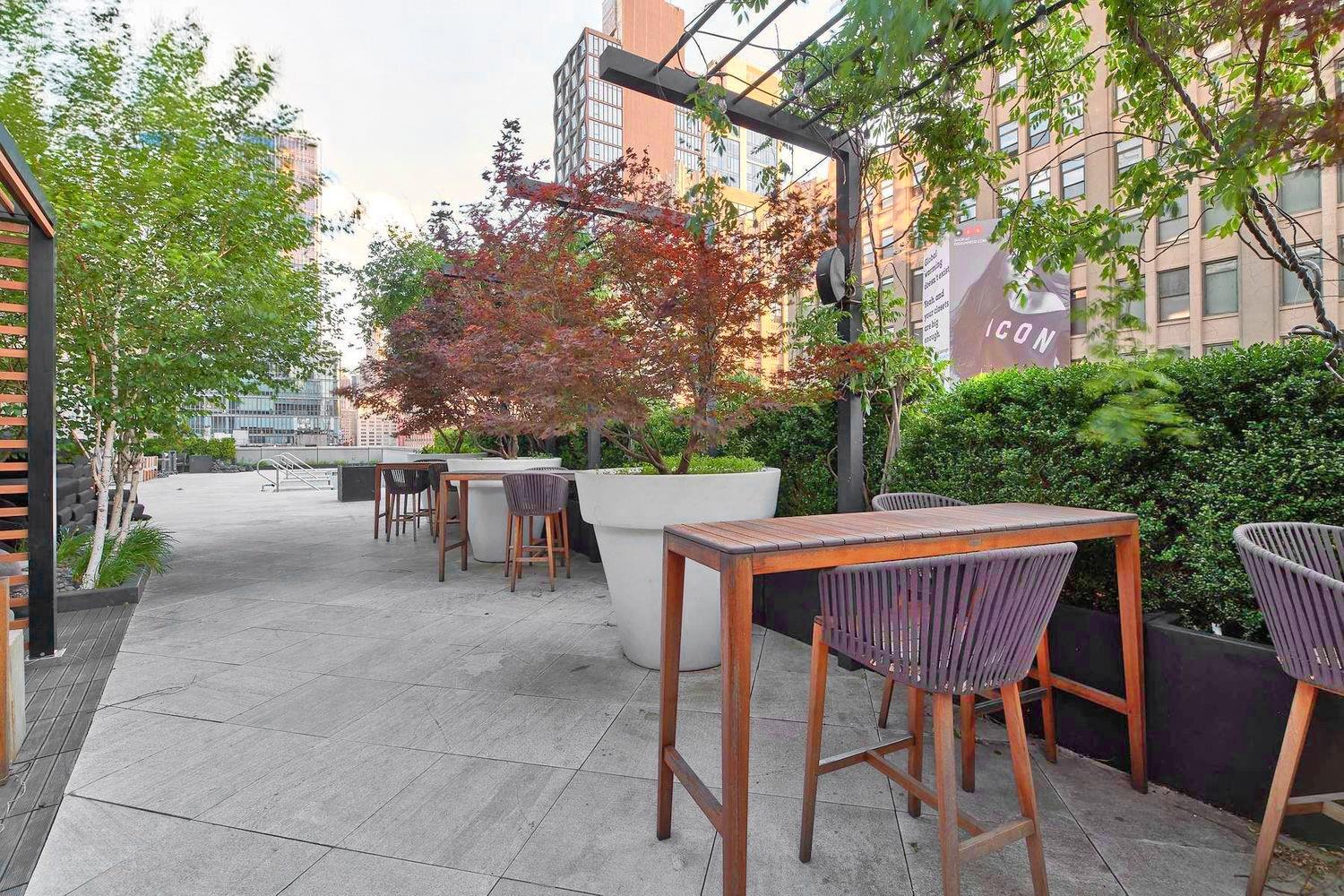246 Spring Street, Unit 3504 Manhattan, NY 10013 - Photo 6 of 11 a patio with hardwood table and chairs