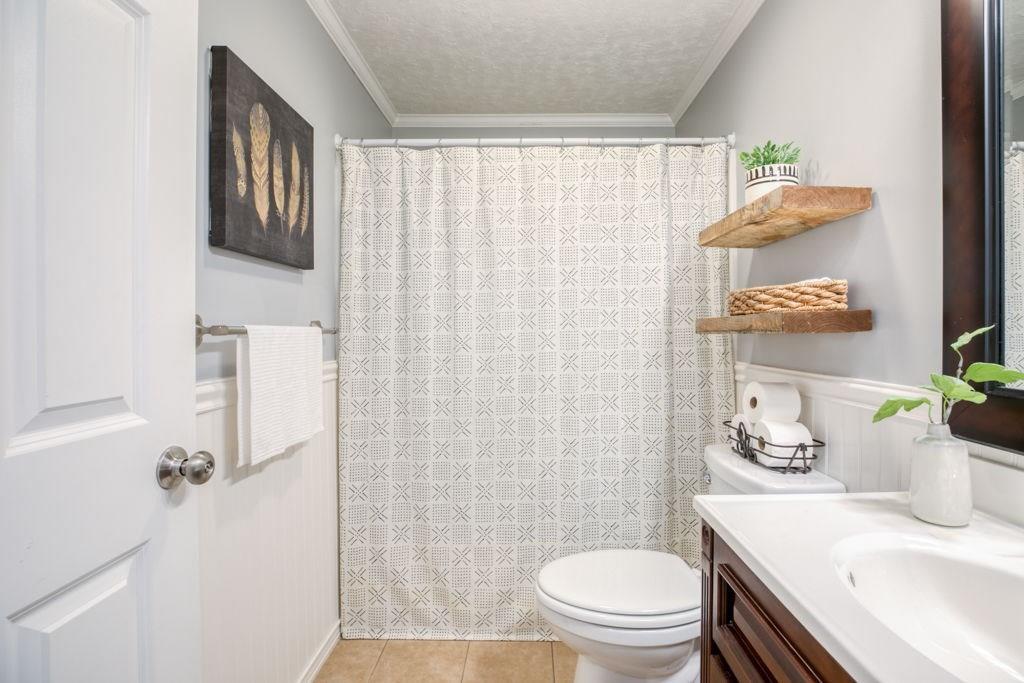 136 Webber Street Springfield, MA 01108 - Photo 14 of 29 a bathroom with a sink a toilet and shower curtain